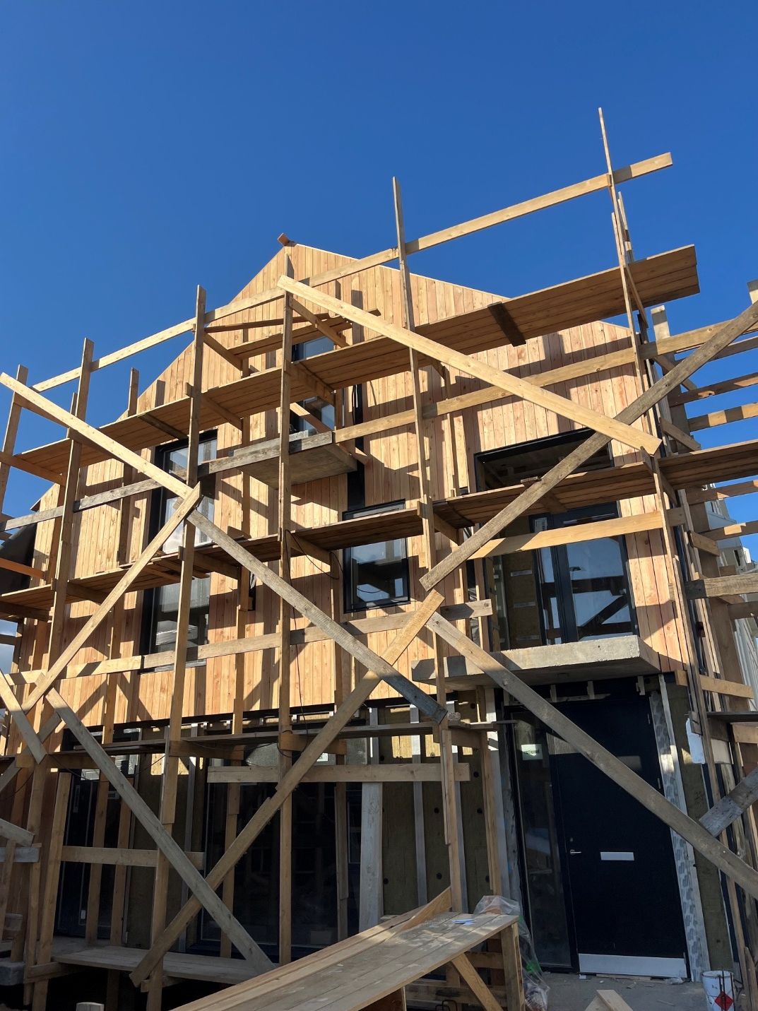Timber building under scaffolding